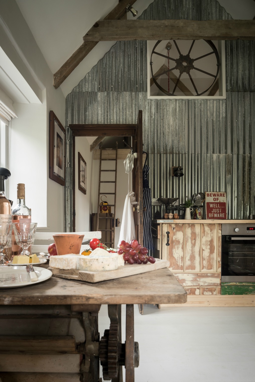 This stunning cottage is filled with vintage finds and industrial style - love the metal wall kellyelko.com
