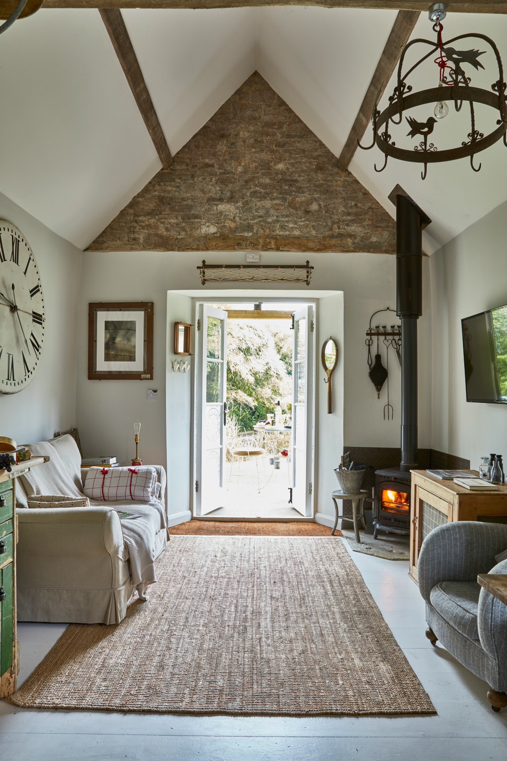 Tiny cottage family room - love the original stone walls and beams kellyelko.com