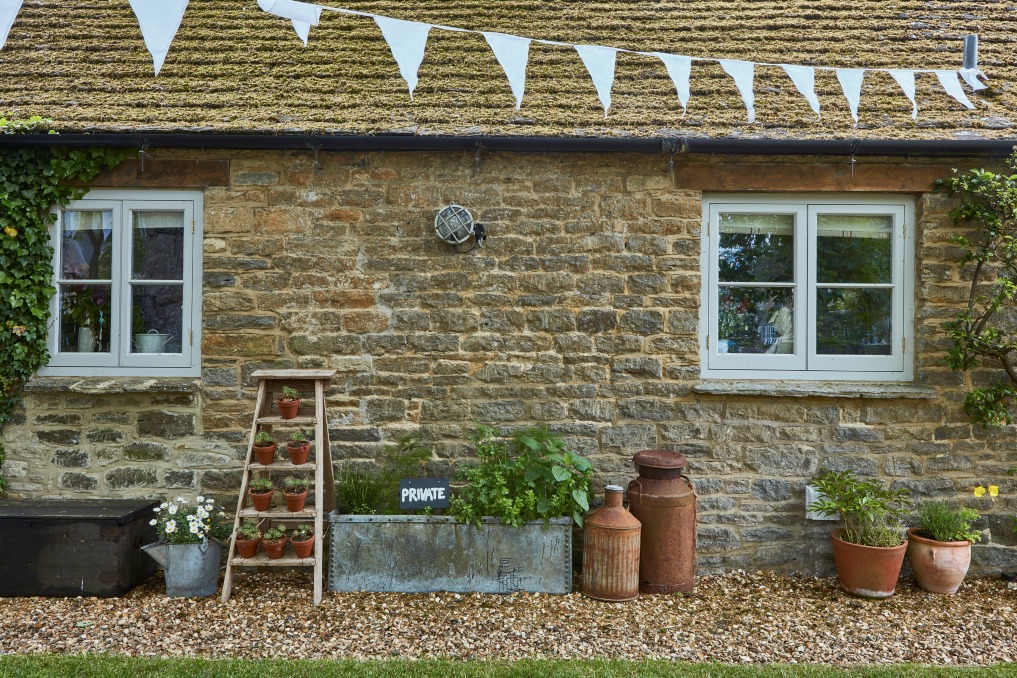 Stone cottage with unique planters kellyelko.com