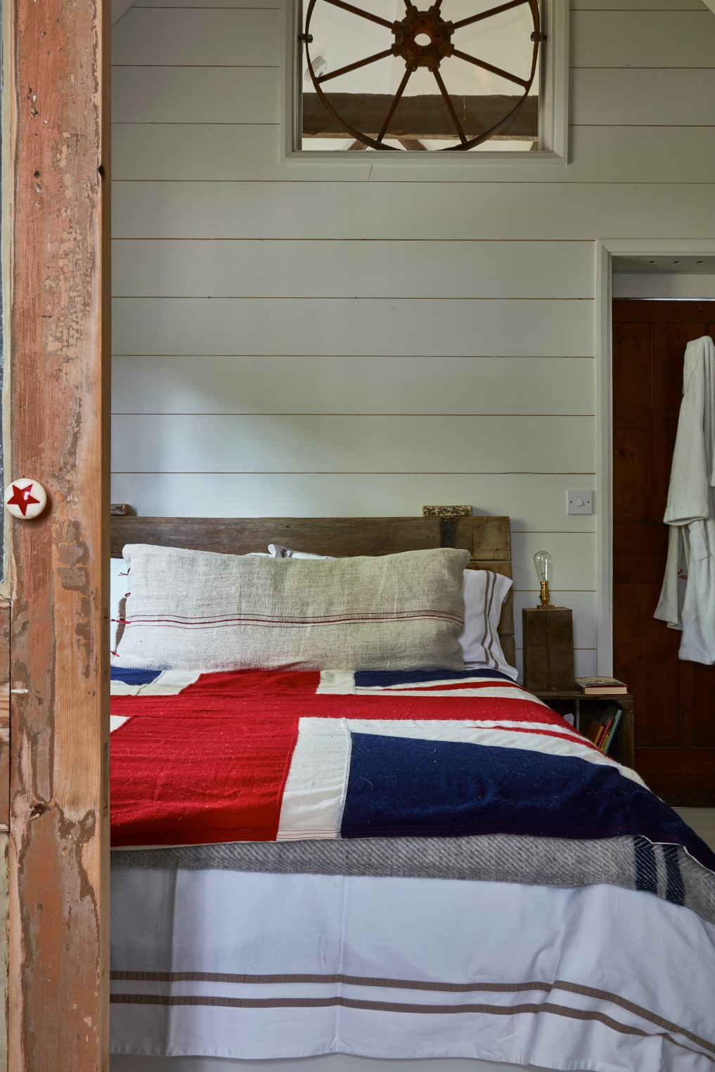 Antique cottage bedroom with planked walls and union jack bedspread kellyelko.com