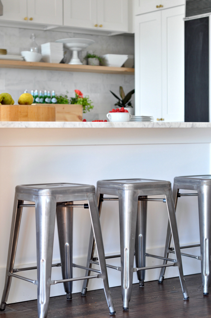 Galvanized counter stools in a white kitchen