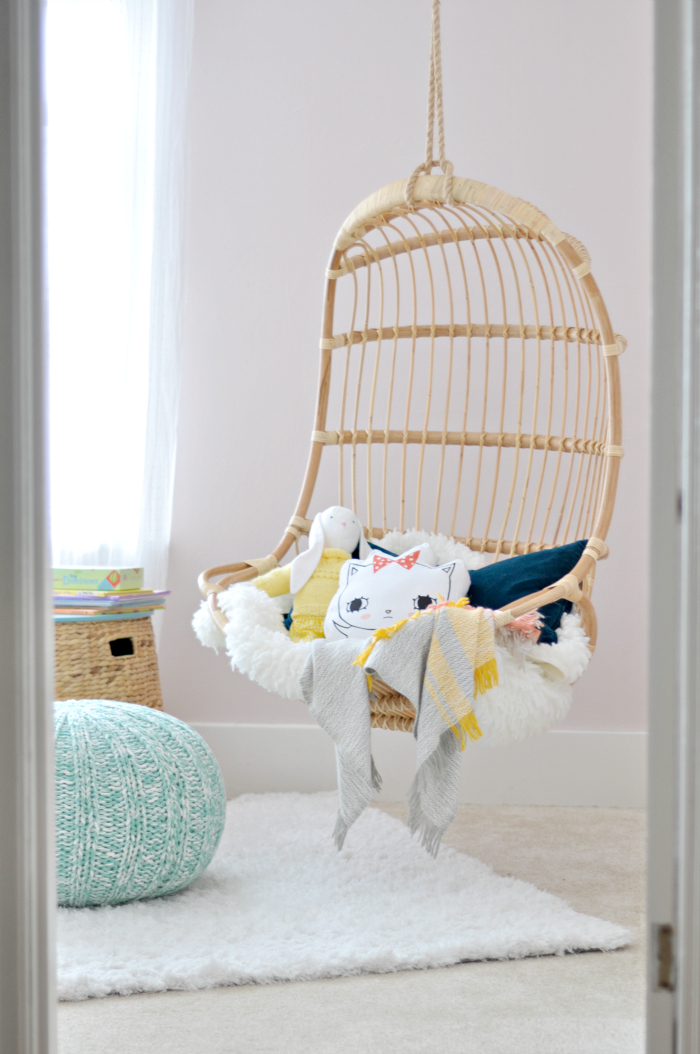 Rattan swing in a little girls bedroom 