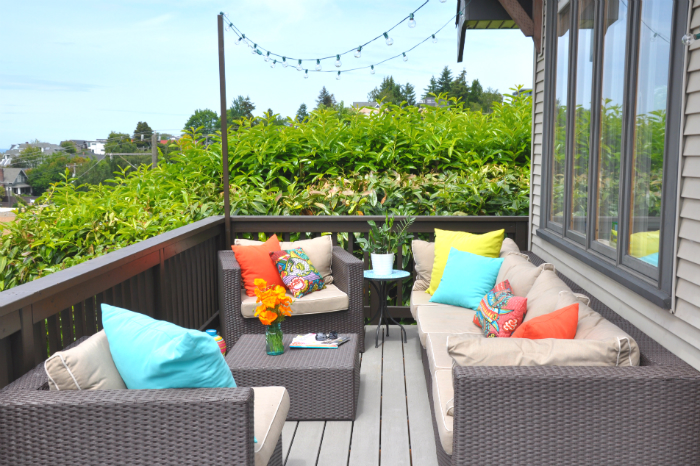 Outdoor deck with modern wicker sofa and chairs 