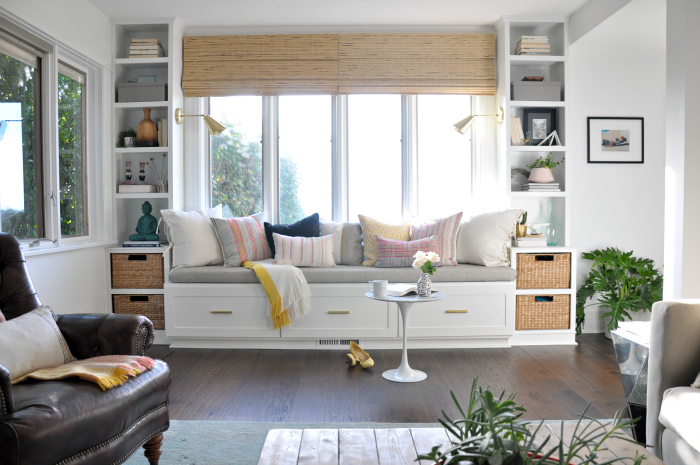 Beautiful built in window seat with bookshelves in this cozy family room