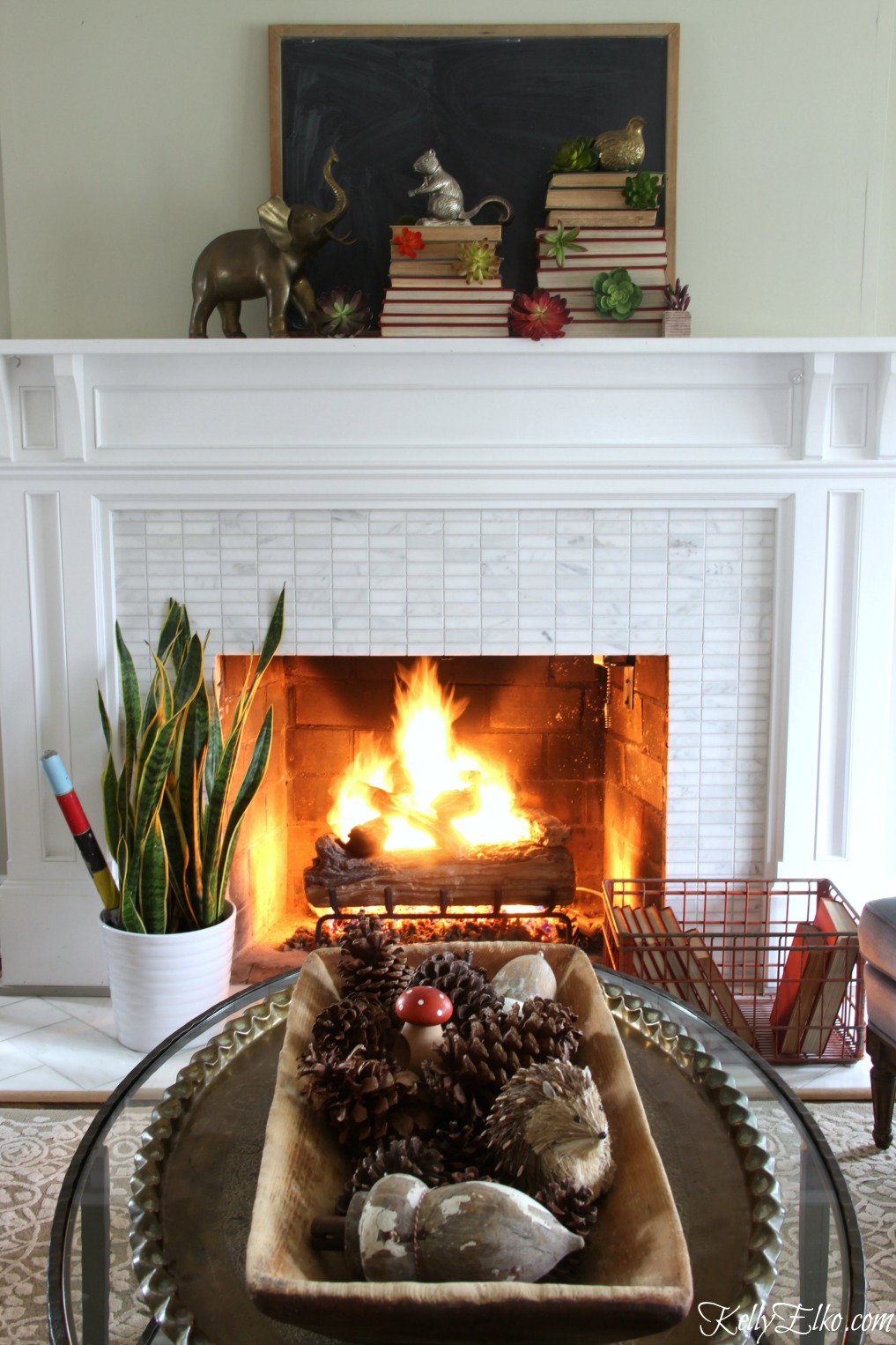 Love this vintage winter mantel with succulents and stacked books kellyelko.com