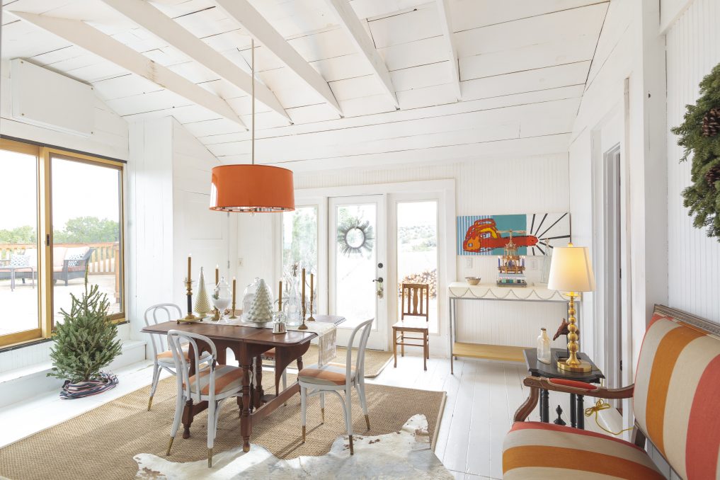 Open and airy dining room with white wood beam ceiling