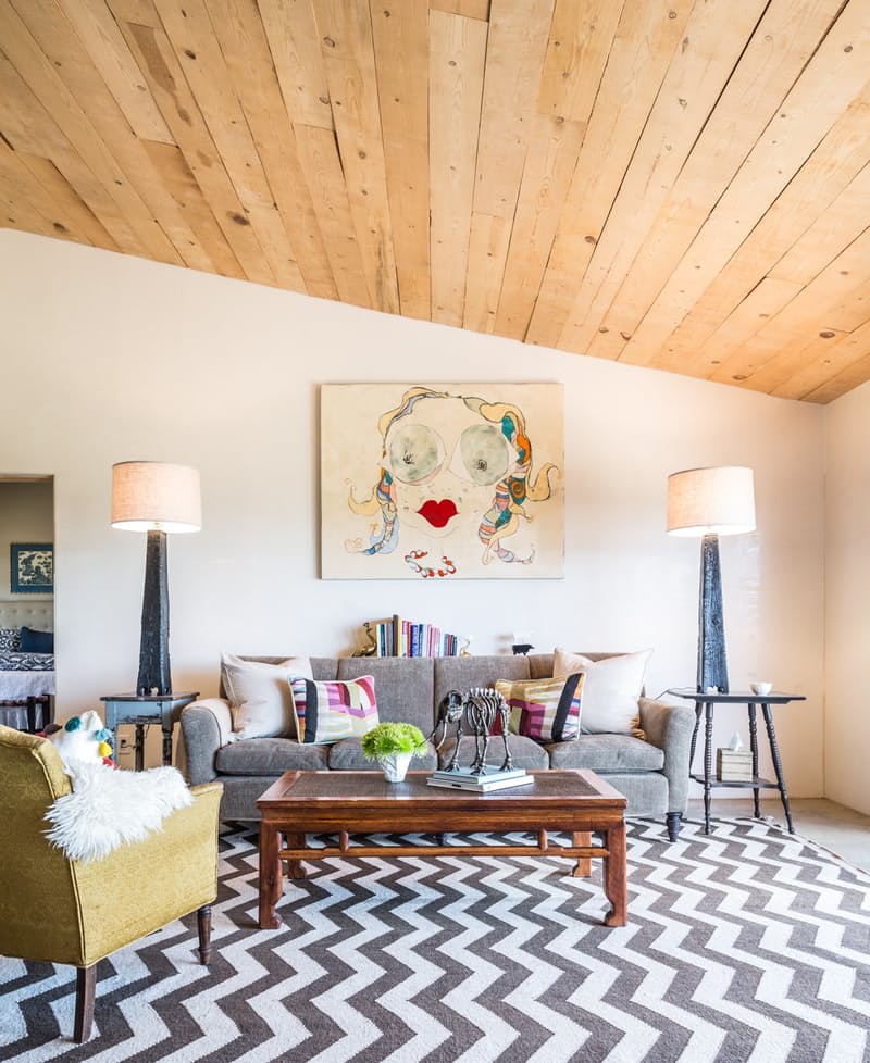 Eclectic living room with wood plank ceiling