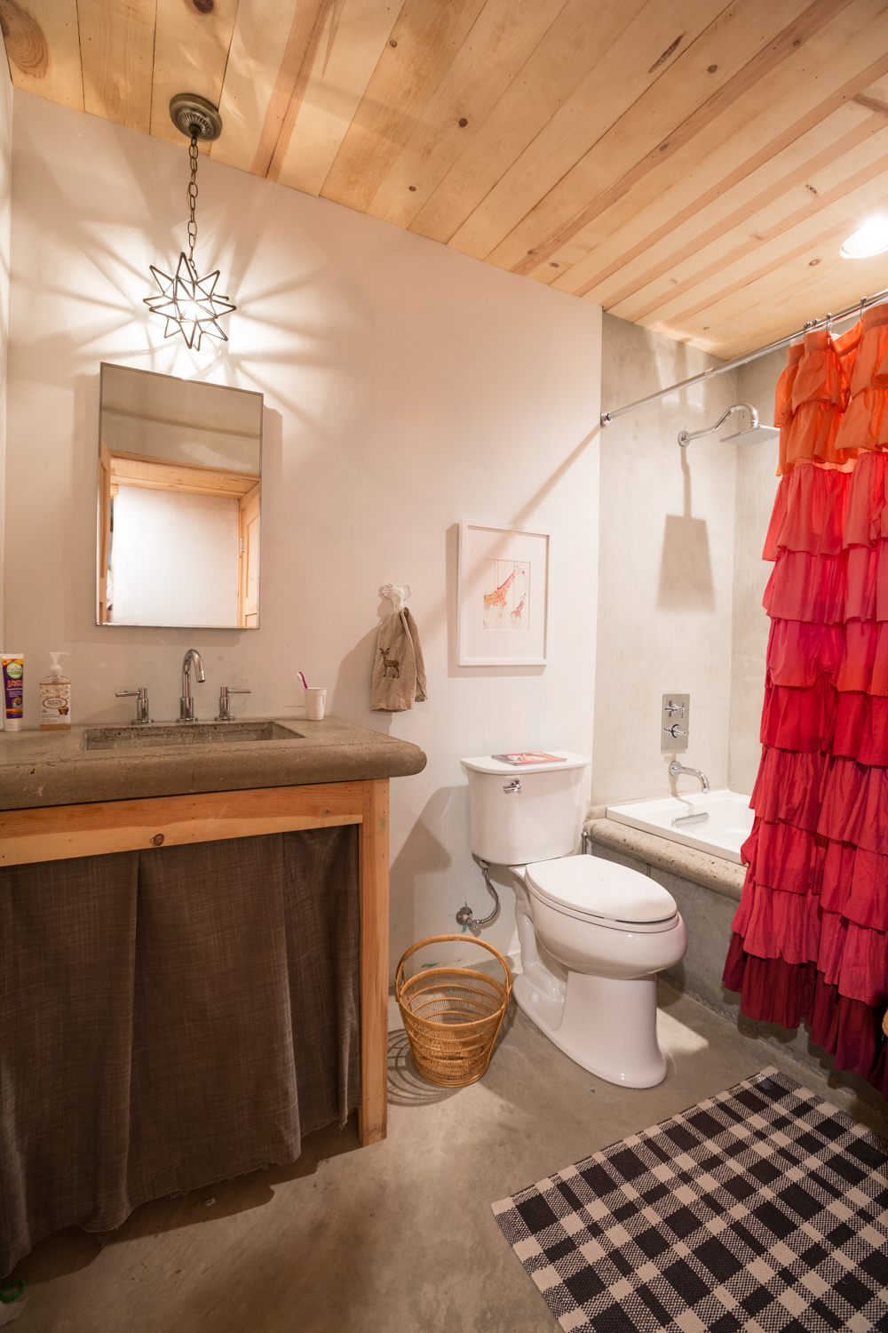 Bathroom with concrete counter and wood base