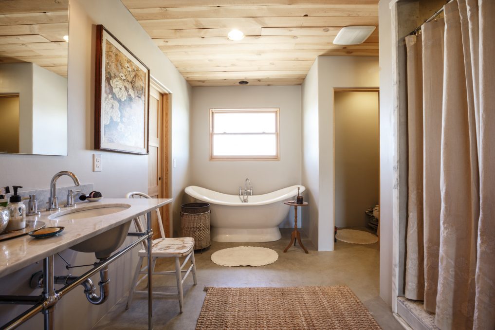 Master bathroom with freestanding tub and chrome and marble vanity 