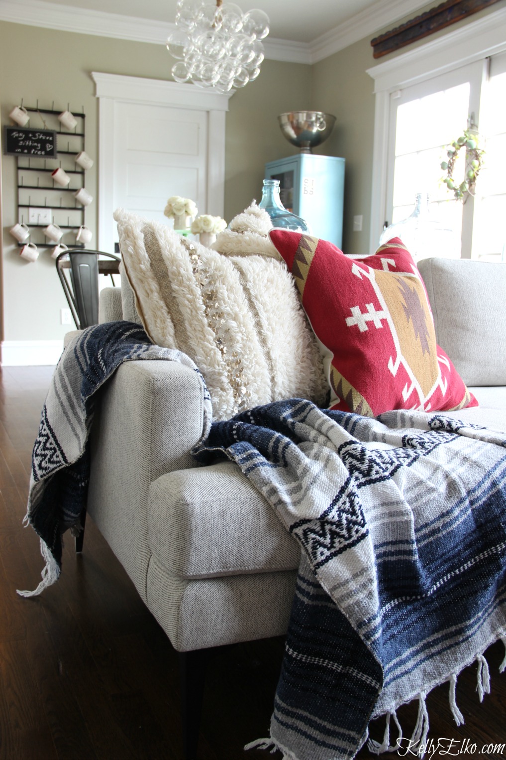 Love this modern sofa with a mix of textiles - Mexican blanket, Moroccan and kilim piillows kellyelko.com