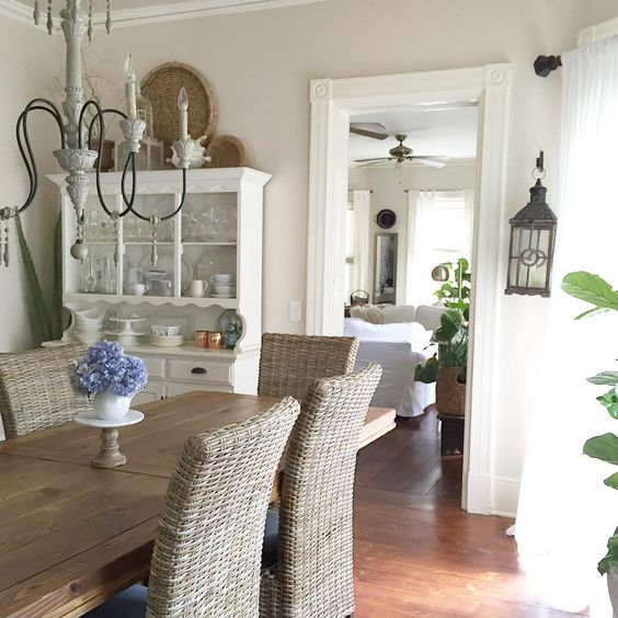 Farmhouse dining room with rustic table and wicker chairs kellyelko.com