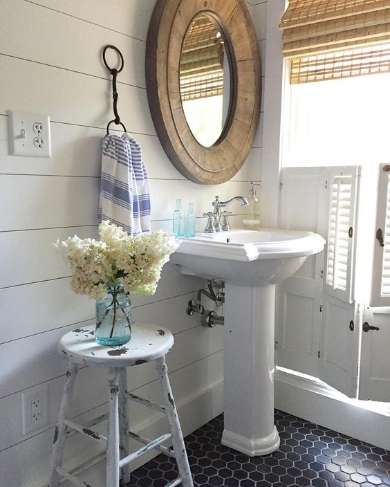 Shiplap walls and black tile in this small farmhouse bathroom kellyelko.com