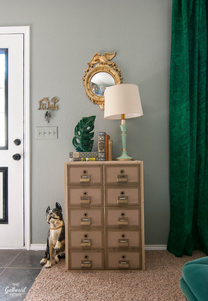 Love this eclectic mix of vintage finds - especially the apothecary cabinet and Boston Terrier sculpture 