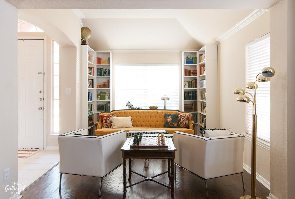 Vintage yellow sofa with pair of white club chairs