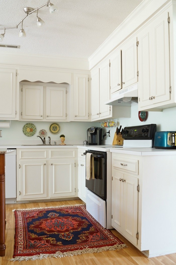 White kitchen with colorful oriental rug