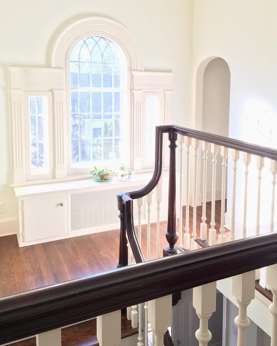 Grand staircase and landing with arched window kellyelko.com