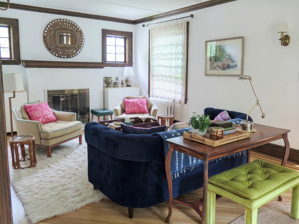 Colorful living room - love the blue velvet Chesterfield sofa and matching club chairs with pops of pink