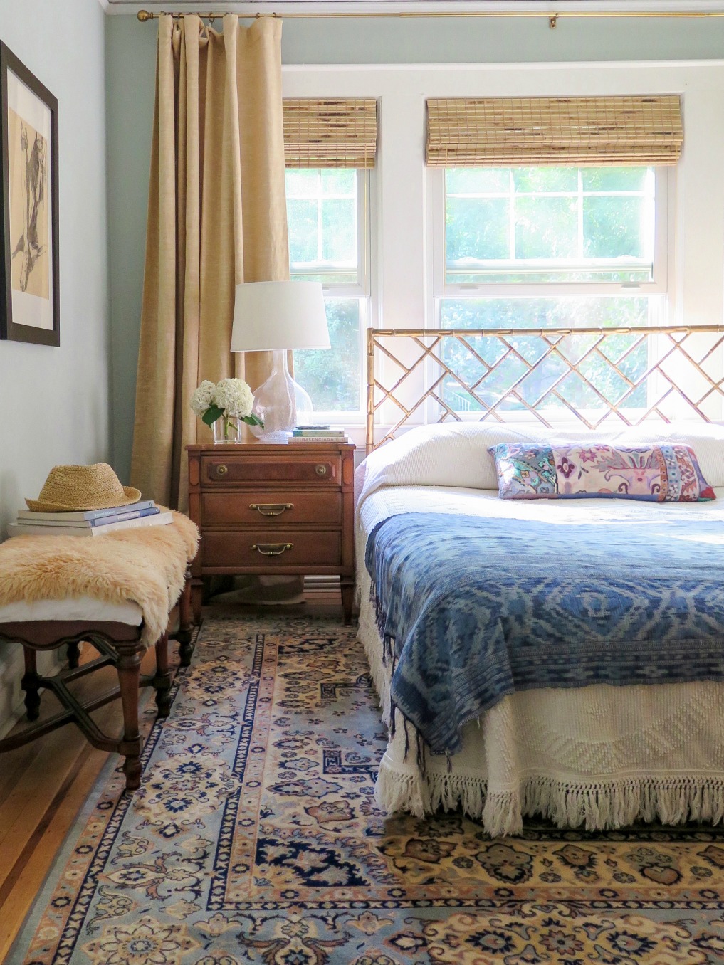 Love this boho bedroom with blue oriental rug, bamboo bed and vintage bedspread