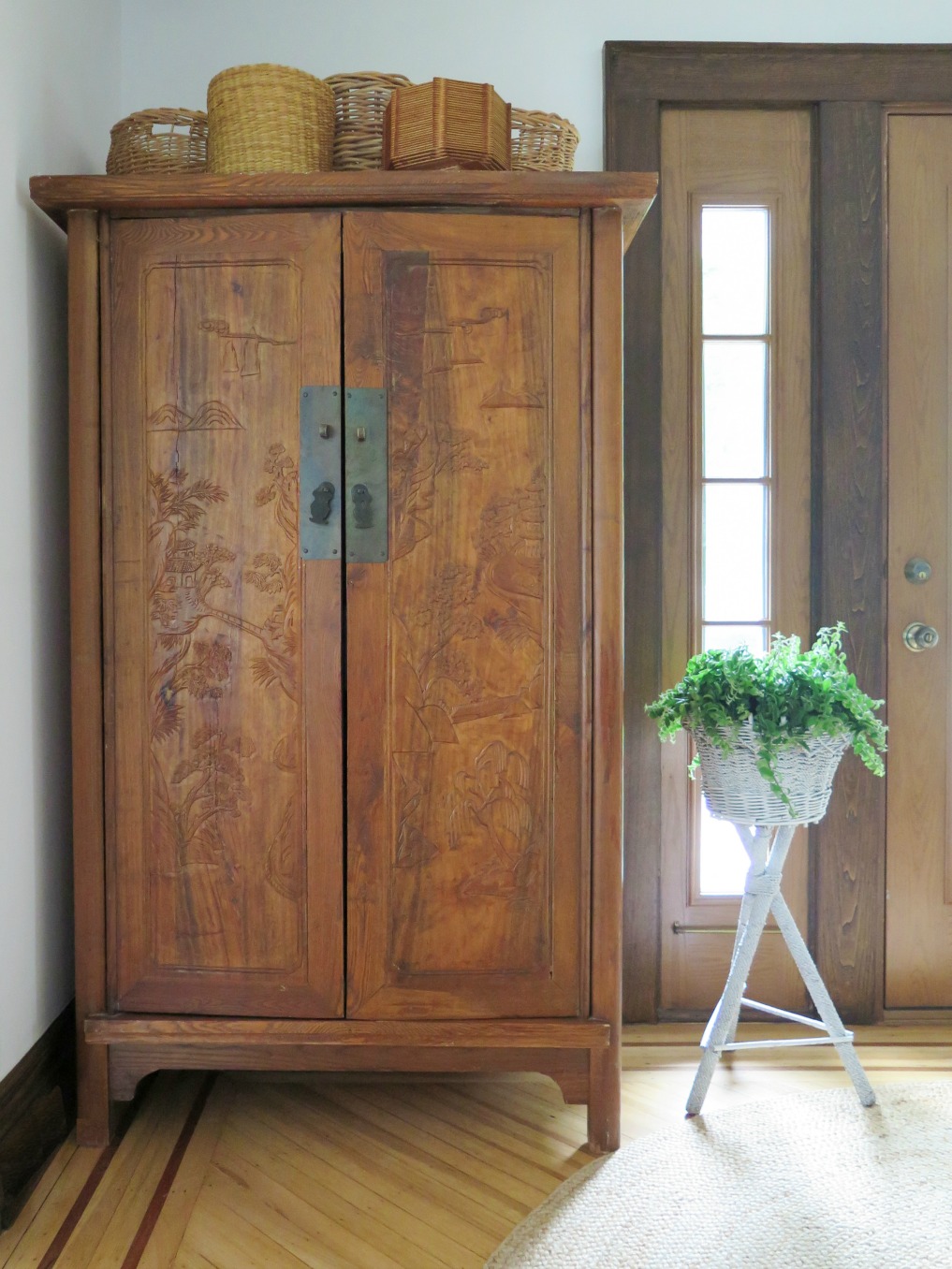 Asian armoire piled with baskets 