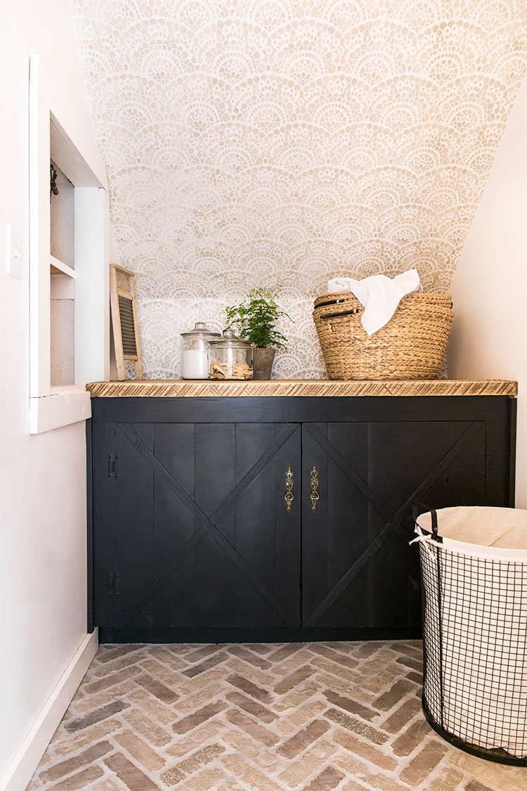 Black cabinets and herringbone brick floors 