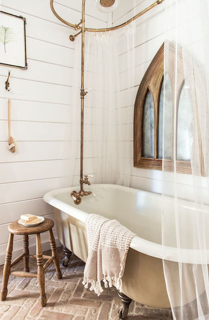 Vintage claw foot bathtub and brass bath fittings give this bathroom a timeless appeal