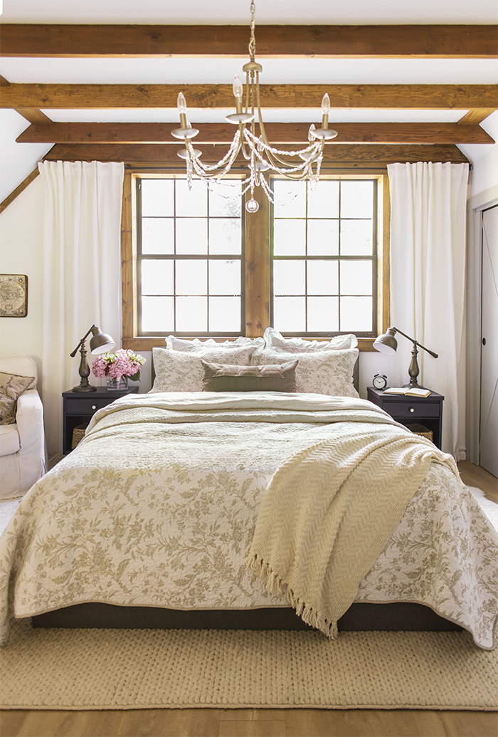 Neutral bedroom with rustic wood ceiling beams