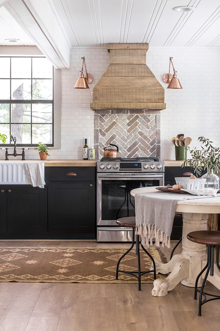 Eclectic Home Tour of Jenna Sue Design Cottage - love this stunning white kitchen with subway tile, brick backsplash and wood range hood kellyelko.com