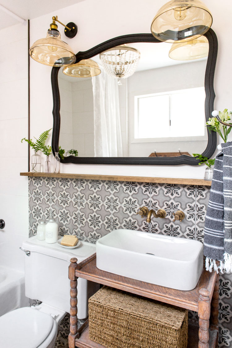 Vintage style lighting adds charm to this cottage bathroom with concrete tile 