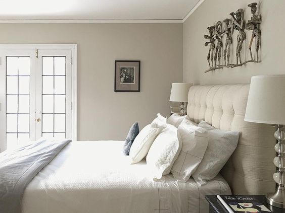 Love this neutral bedroom with tufted headboard and unique art kellyelko.com