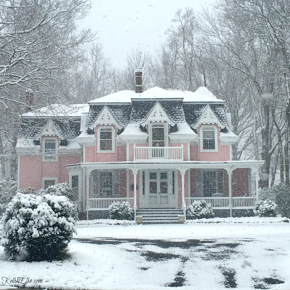 Beautiful old Victorian home in pink! Love the architecture and details kellyelko.com #victorian #oldhomes #oldhouses #curbappeal #pinkhouse #pinkhome #winterhome #letitsnow #kellyelko