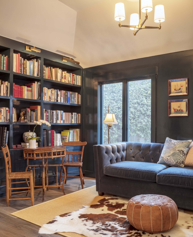 High gloss black paint creates drama when used on the walls, trim and bookcases in this study