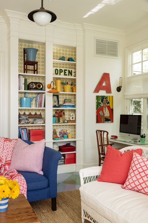 Bookshelves backed with colorful wallpaper