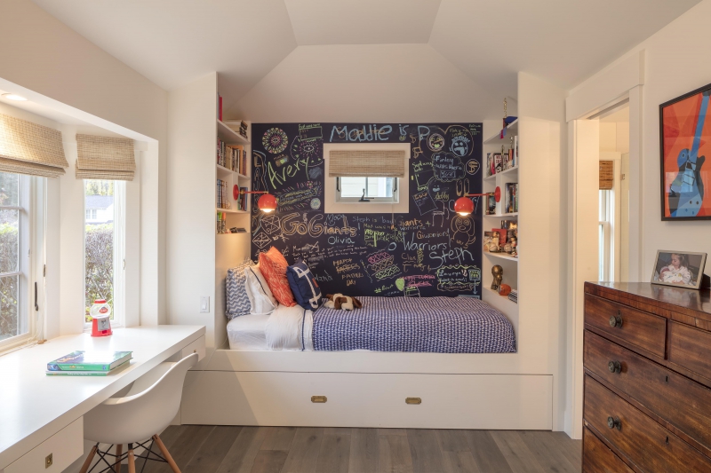 Kids bedroom with built in bed, bookshelves and desk maximize space 