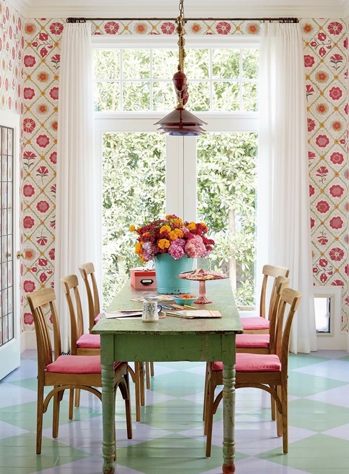 Colorful dining room in pinks and greens with floral wallpaper 