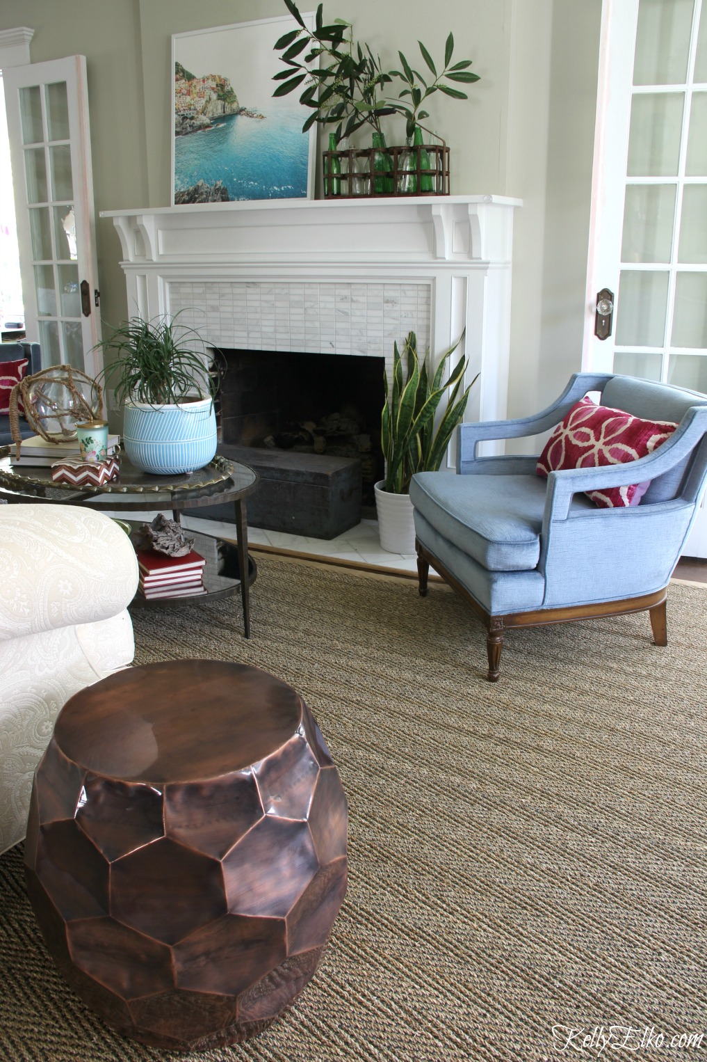 Beautiful living room in shades of blue - love the seagrass rug and vintage blue velvet chairs kellyelko.com #sisal #sisalrug #rugs #livingroomdecor #manteldecor #kellyelko