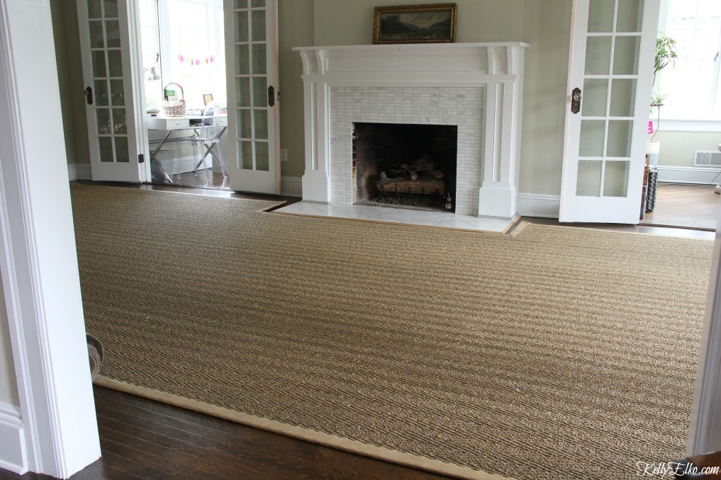 Custom sisal rug is cut to fit around a fireplace hearth and is perfect for oddly shaped rooms kellyelko.com