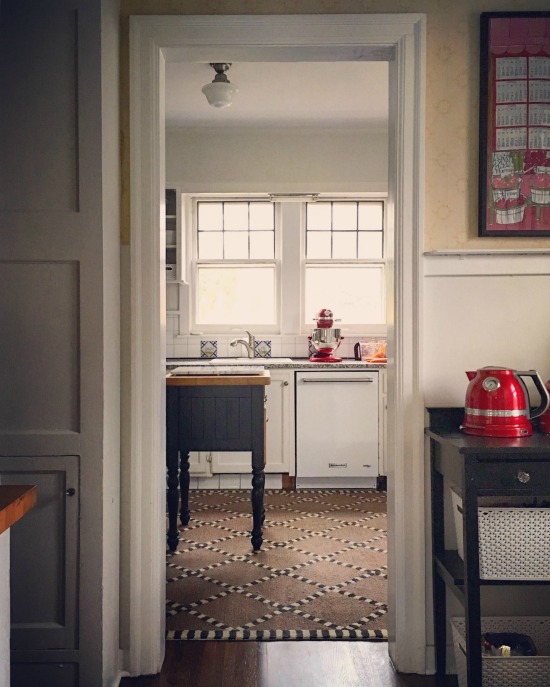 Small cottage kitchen with butcher block island kellyelko.com