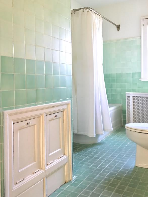 Antique green tile bathroom with laundry chute kellyelko.com