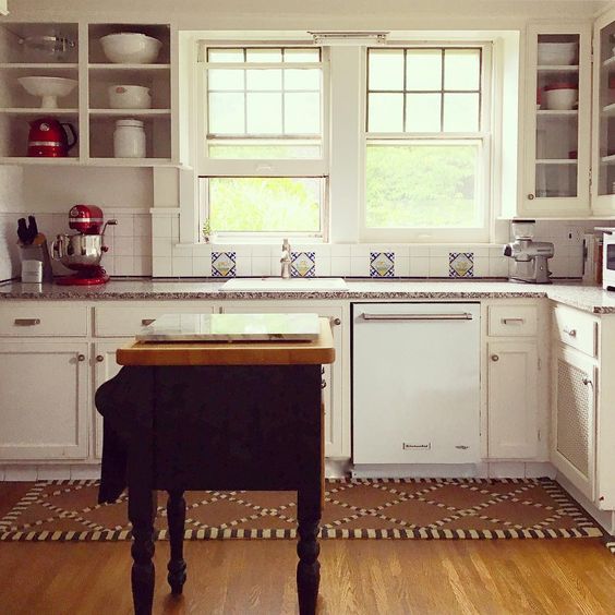 Country cottage kitchen with black butcher block island kellyelko.com