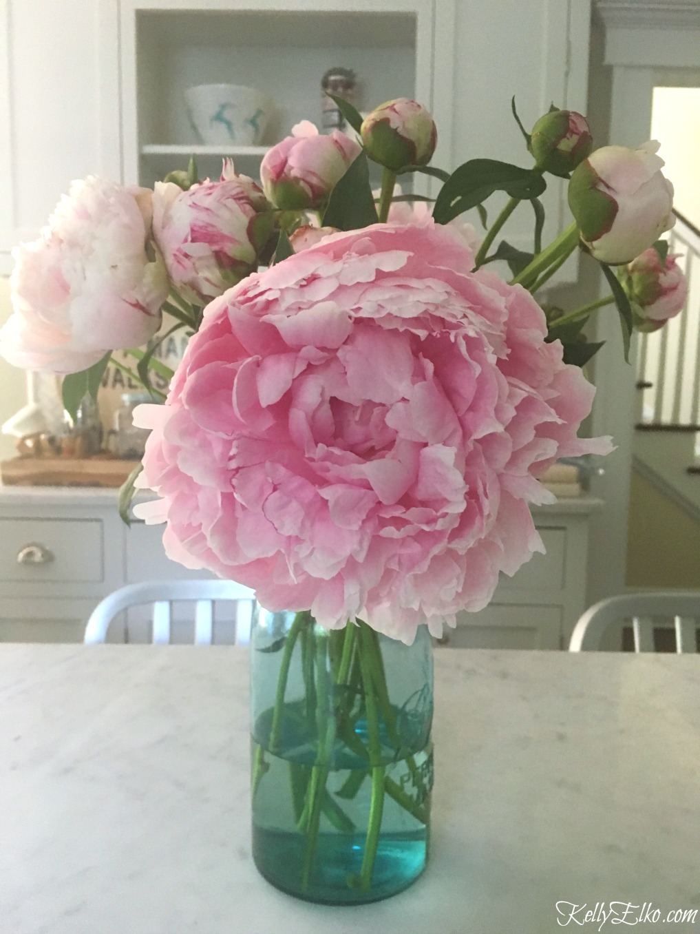 Pink peonies in a mason jar - get tips for planting peonies so they bloom kellyelko.com