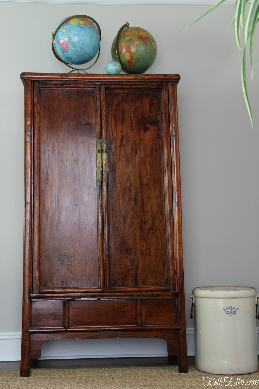 Asian armoire with vintage globes kellyelko.com