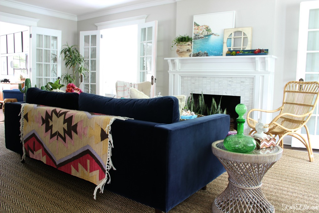 Colorful living room - love the blue velvet sofa with rug thrown over back for more color and texture kellyelko.com