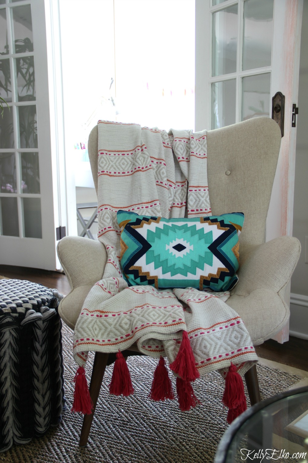 Love this mid century style chair with colorful pink tassel throw kellyelko.com