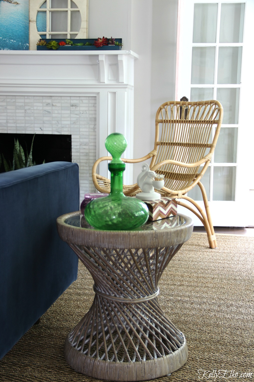 A rattan table and chair and seagrass rug add so much texture to this living room kellyelko.com