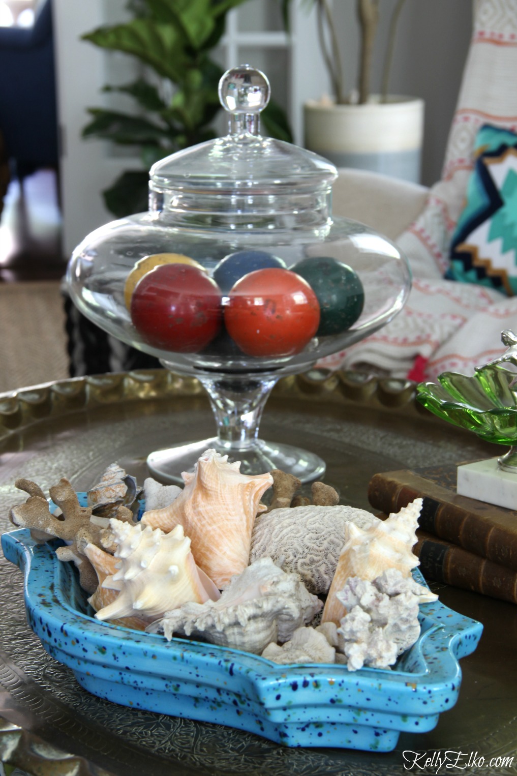 Vintage ashtray filled with shells and a jar of croquet balls makes a unique coffee table display kellyelko.com