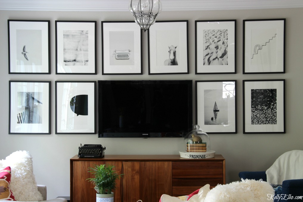 Love this black and white TV gallery wall to help camoflauge the television kellyelko.com