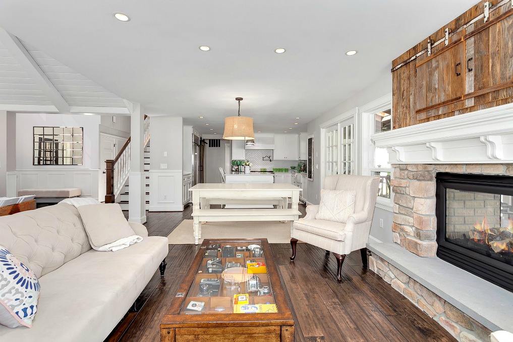 Farmhouse family room - love the barn doors over the fireplace to hide TV kellyelko.com