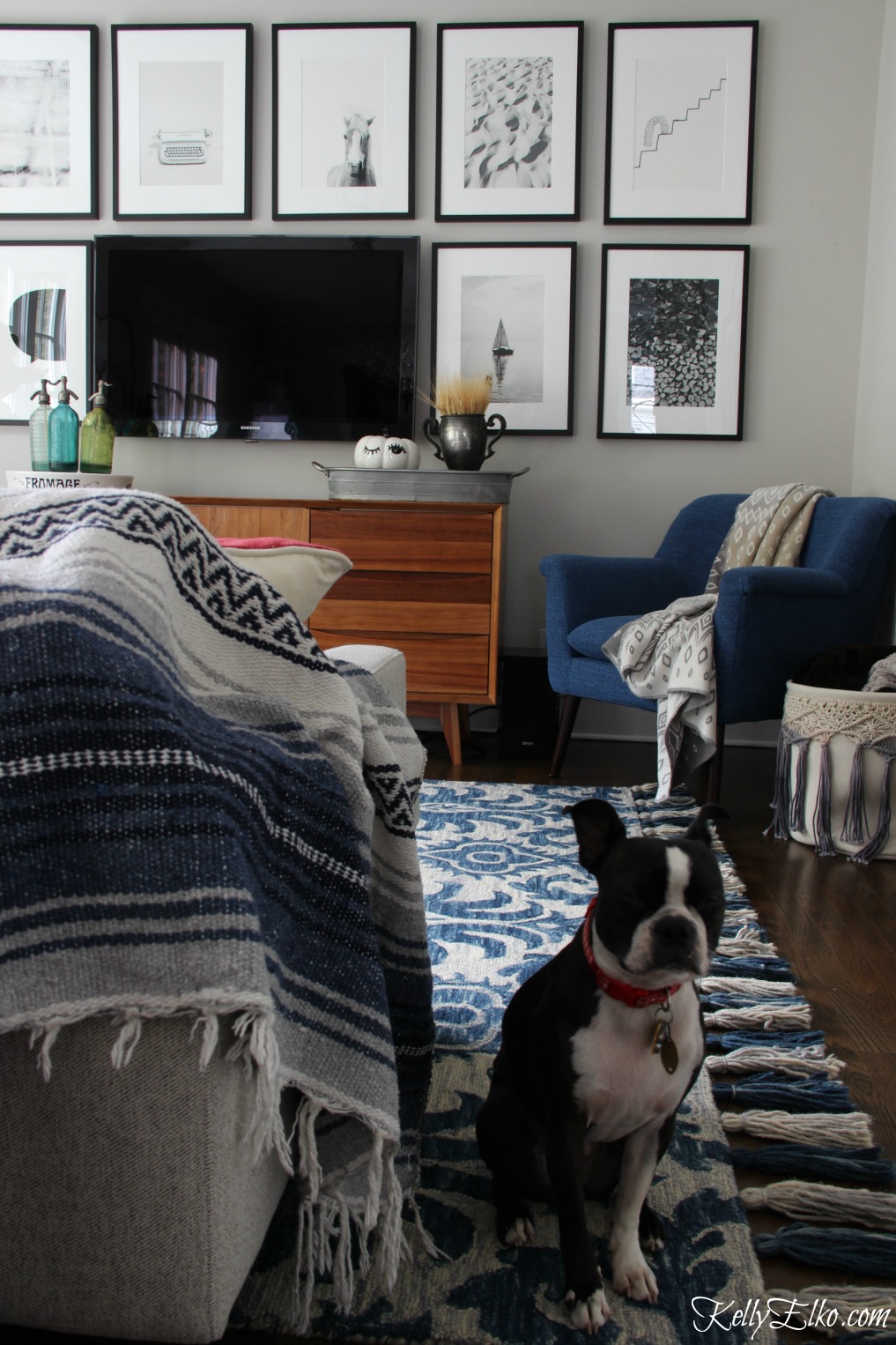 Love this family room with blue Loloi tassel rug and beautiful tv gallery wall kellyelko.com