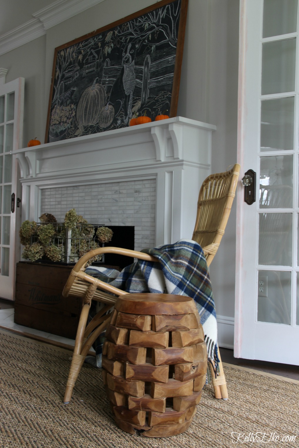 Eclectic living room with wicker, wood and sisal and a giant chalkboard kellyelko.com