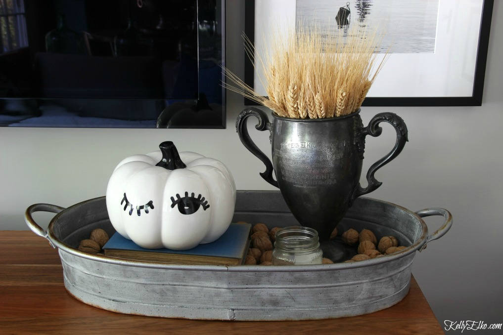 Winking pumpkin and vintage trophy filled with wheat for fall kellyelko.com